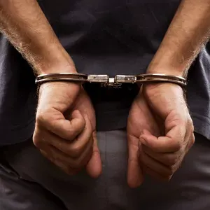Man with hand cuffs on behind his back