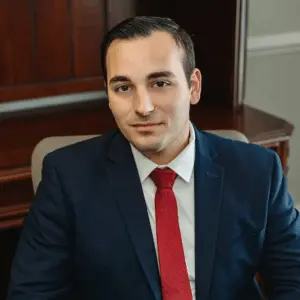 Attorney Max Frizalone seated at his desk